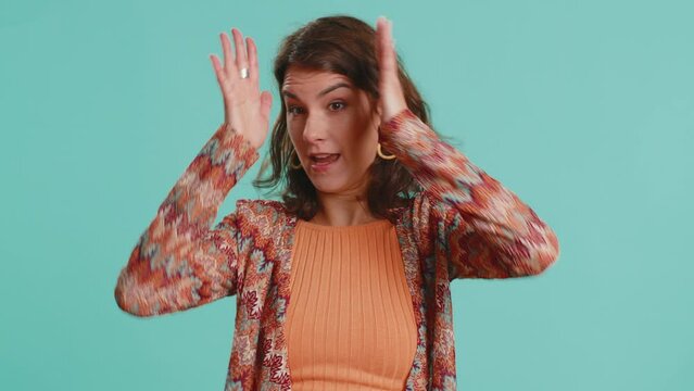 Dont want to hear and listen. Frustrated annoyed irritated woman covering ears gesturing No, avoiding advice ignoring unpleasant noise loud voices. Brunette girl isolated alone on blue background