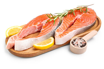 Wooden board with raw salmon steaks and different spices on white background