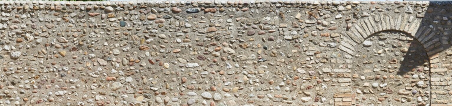 Typical rustic castle wall in Tuscany, in panoramic format.