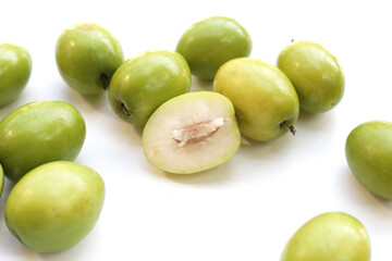 Green jujube fruits on white background.