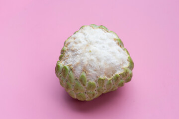 Custard apple fruit on pink background.