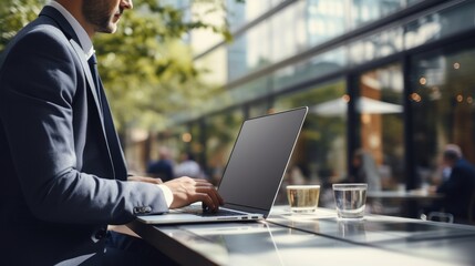 Businessman working outdoors with laptop