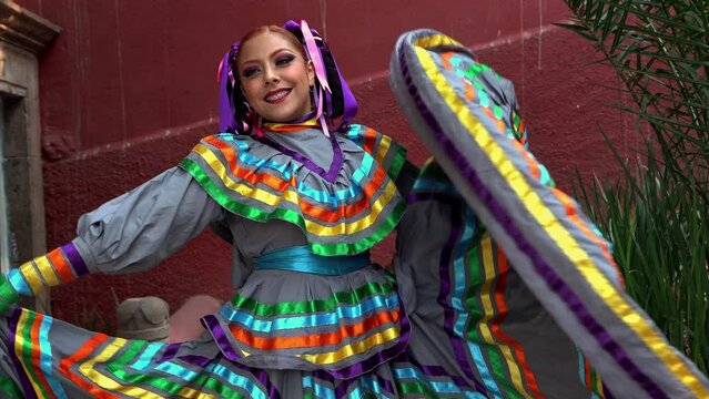 Young Mexican woman in a traditional folklore dress of many colors, traditional dancer.	 China poblana close up