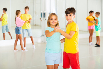 Boys and girls dancing waltz during their group class.