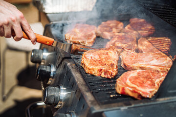 Placing Marinated Steaks on a Grill 2