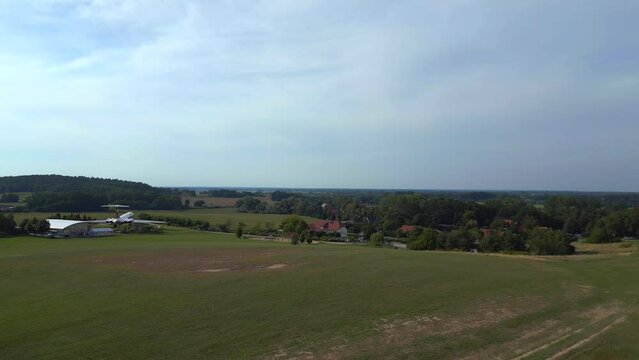 Best aerial top view flight drone. II-62 aircraft on ground. hilly summer fields
