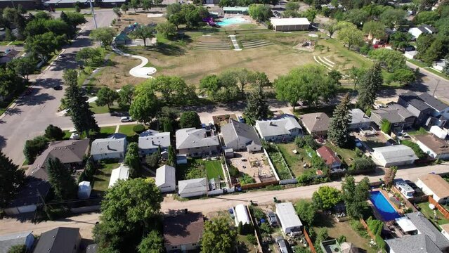 Aerial video of Haultain, Saskatoon, SK, capturing the charm of its tree-canopied streets, vintage homes, and neighborhood ambiance. A historic enclave resonating community warmth.