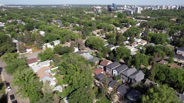 Aerial video of Haultain, Saskatoon, SK, capturing the charm of its tree-canopied streets, vintage homes, and neighborhood ambiance. A historic enclave resonating community warmth.