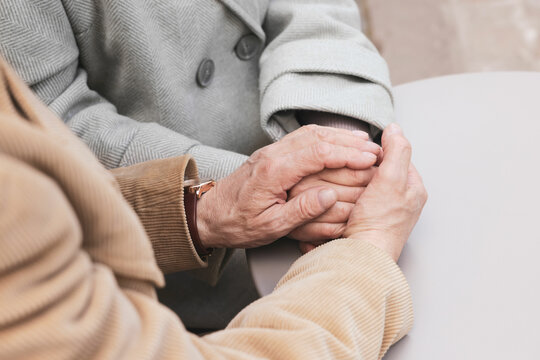 Affectionate senior couple sitting at table, closeup - Powered by Adobe