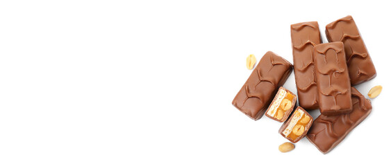 Tasty chocolate bars with caramel and nuts on white background, top view. Space for text