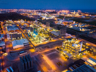 Night aerial panoramic view of large chemical plant located next to Salou city, Spain