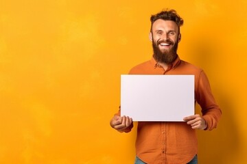 Generative AI : Happy bearded guy smiling and holding blank speech balloon near head against yellow background