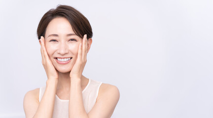Skin care. Woman with beauty face touching healthy facial skin portrait. Asian woman.	
