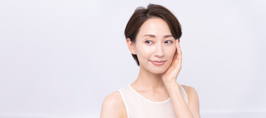 Skin care. Woman with beauty face touching healthy facial skin portrait. Asian woman.	
