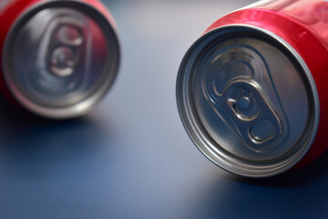 close up aluminium red cans soft drink put on blue texture background