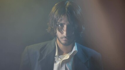 Cinema-like footage of a gangster mafia boss tied to a chair in an intriguing and one-of-a-kind setting with dramatic creative lighting, Full HD stock video.