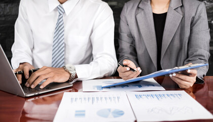 Two business leaders talk about charts, financial graphs showing results are analyzing and calculating planning strategies, business success building processes