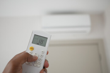 Close up of man hand holding air condition remote.
