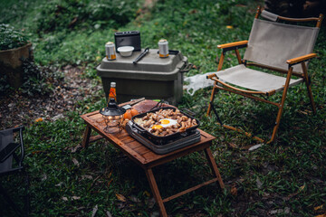 Fried eggs and grilled pork in a camping pan