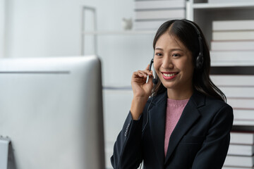 Asia call center with headset and microphone working on laptop Female entrepreneurs serving customers, business information, inquiries Support call center representatives help customers.