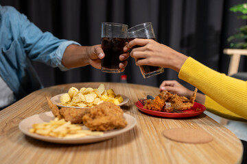 Group of happy asian young people celebrating clinking glasses drinks During a party in the living room of the home office Christmas or New Year's party lifestyle concept, study, work, holiday.