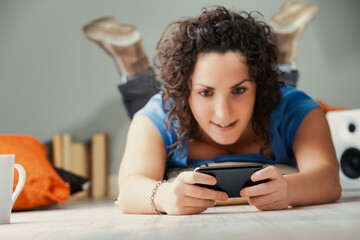 Digital adventures await; she's relaxed, cushion-surrounded