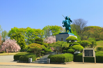 Statue of Yoshimitsu Mogami on horseback and weeping cherry tree in Kasumijo Park, Japan,Yamagata Prefecture,Yamagata, Yamagata