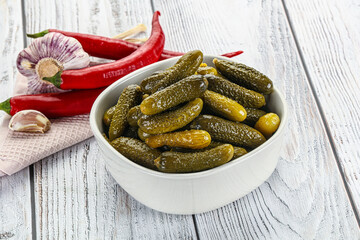 Marinated small cucumbers in the bowl