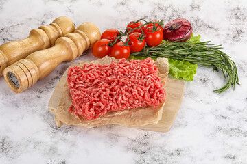 Raw minced beef meat on cutting board