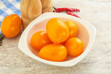 Sweet ripe yellow tomato in the bowl