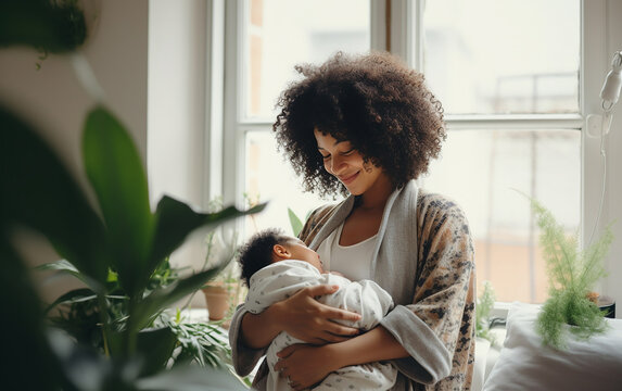 Black african american dark-skinned happy loving mother takes care of her newborn at home