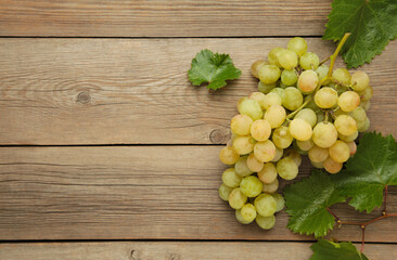Shine Muscat Grape. Bunch of green grape with leaves on grey wooden background.