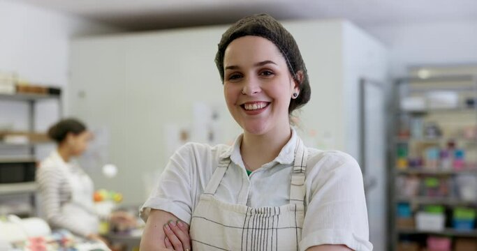 Happy woman, portrait and smile in bakery with employee, apron and working in cafe kitchen with service and catering. Face, baker and laughing with arms crossed, confidence and professional chef