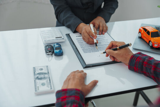 Businessman completes successful car purchase transaction by gifting car keys after finalizing contract signing, great investment, handover of keys, satisfaction purchase new or used vehicle