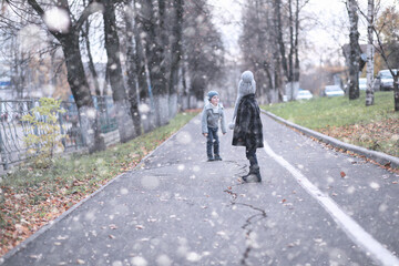 Kids walk in the park first snow