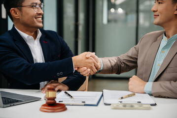 Business law concept, Lawyer business lawyers are consulting lawyers for women entrepreneurs to file copyright lawsuit with laptop and tablet at office .