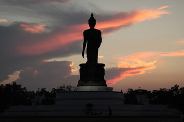 The shadow of the Buddha in the center of the picture and the clouds at sunset