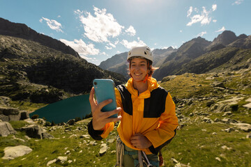 Person climbing in high mountains with yellow jacket rope and helmet in nature, confidence and...