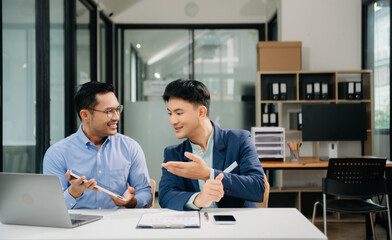 Male discussing new project with business colleague. Young man talking with young man in office.