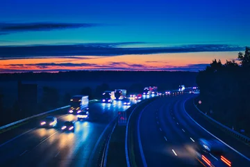 Fototapeten Traffic on the Highway - Travel - Background - Line - Ecology - Long Exposure - Motorway - Night Traffic - Light Trails - High Quality Photo  © Enrico Obergefäll