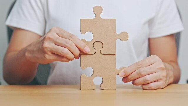 Hand connecting couple puzzle piece. Business Solving, mission, challenge, success, goals, target and strategy concepts