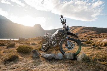 Dual purpose motorbike on roads mountain of Peru at sunset