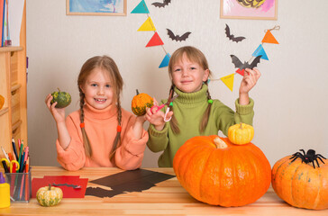 Fototapeta premium Smiling girls making decorations for Halloween.