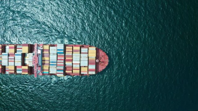 4K resolution high angle view of a container ship sailing at the sea for transportation.