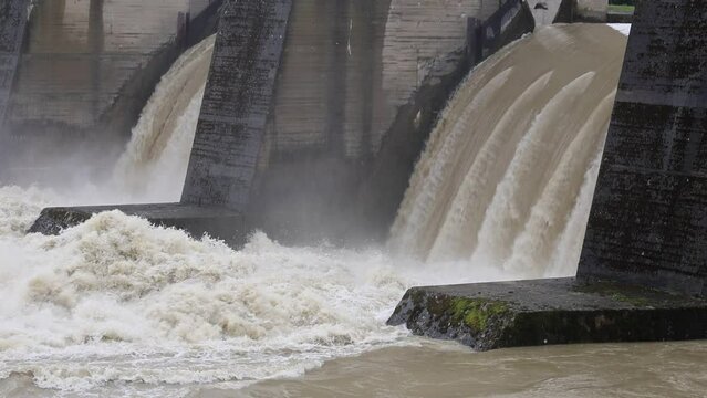 Slowmotion video of flooding in the river Lech near Augsburg  in Bavaria, Germany due to severe weather, massive rainfall and storms. High water levels in the river, overflowing in the power station.