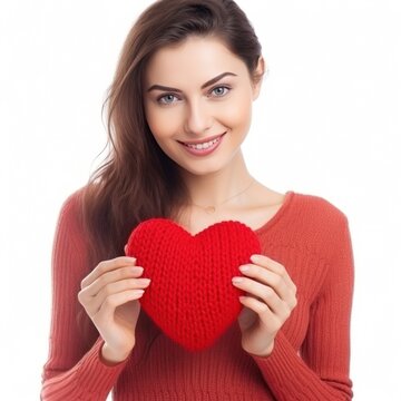 Happy young woman wigth knitted heart in hands