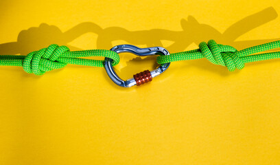 Steel carabiner with clutch. Equipment for climbing and mountaineering. Safety rope. Node eight.