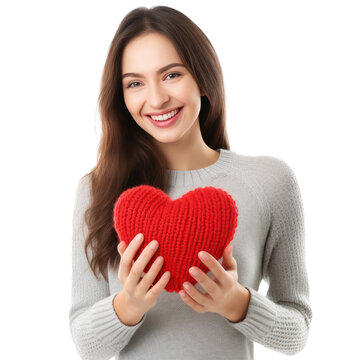 Happy young woman wigth knitted heart in hands