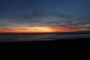 Fototapeta na wymiar Sunset on the Zapillo beach in Almeria, Spain, sun hidden behind the horizon