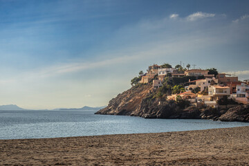 Fototapeta premium Bolnuevo beach, romantic coastal landscape with houses on a hill, Spain
